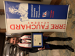 alt="Dr. Greg Feldman holding his Fellowship plaque in front of a banner at the Pierre Fauchard Academy Induction Ceremony at the Ritz Carlton Lake Oconee.""