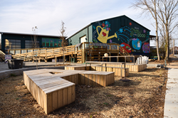 The CreateATL parklet and participatory art installation by Tina Medico provide a warm and welcoming entrance to the neighborhood workspace. Photo by Erin Sintos.