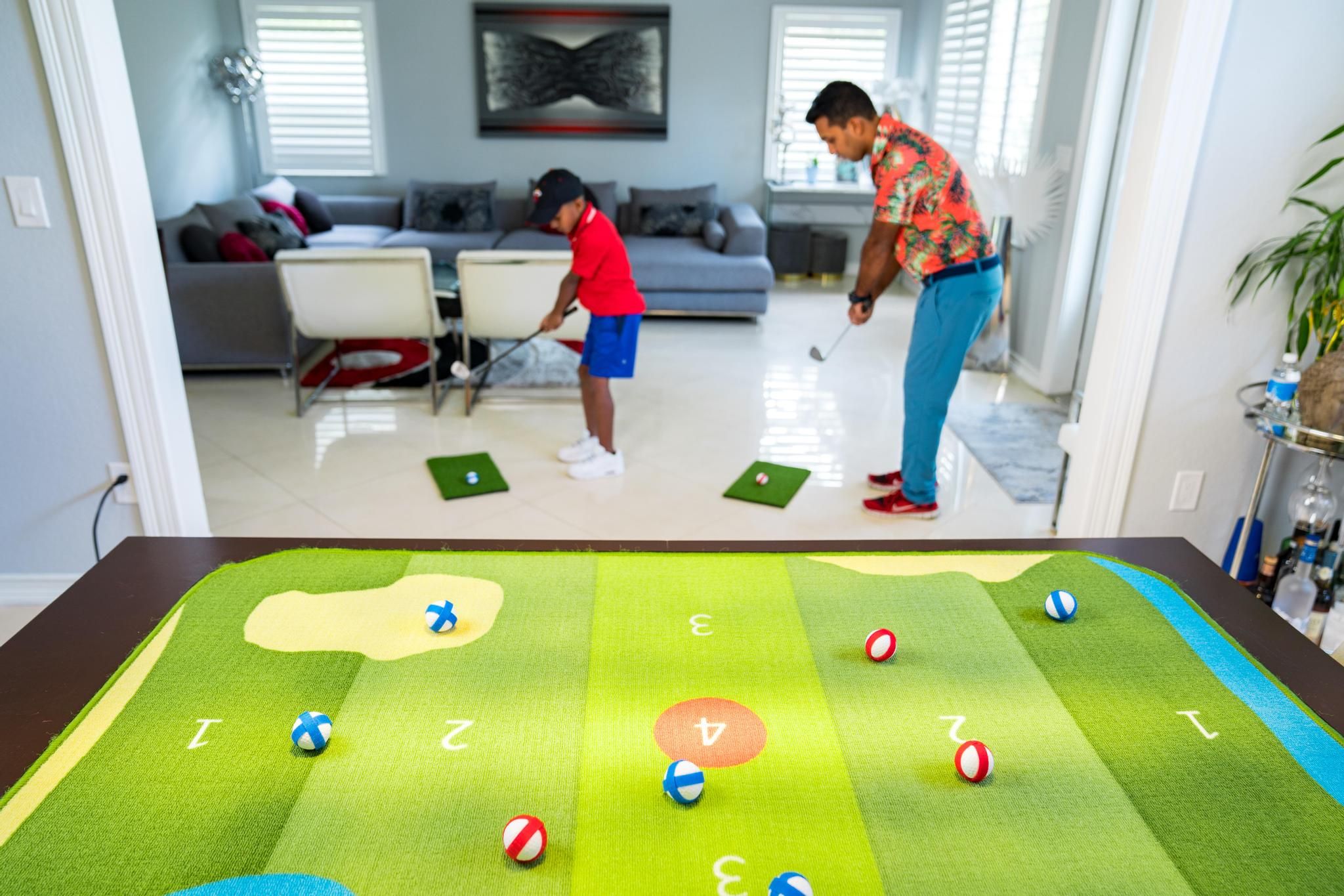Father and Son Playing Golf at Home