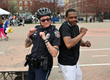 A local law enforcement officer poses with a community member during last year’s Zeigler Kalamazoo Marathon