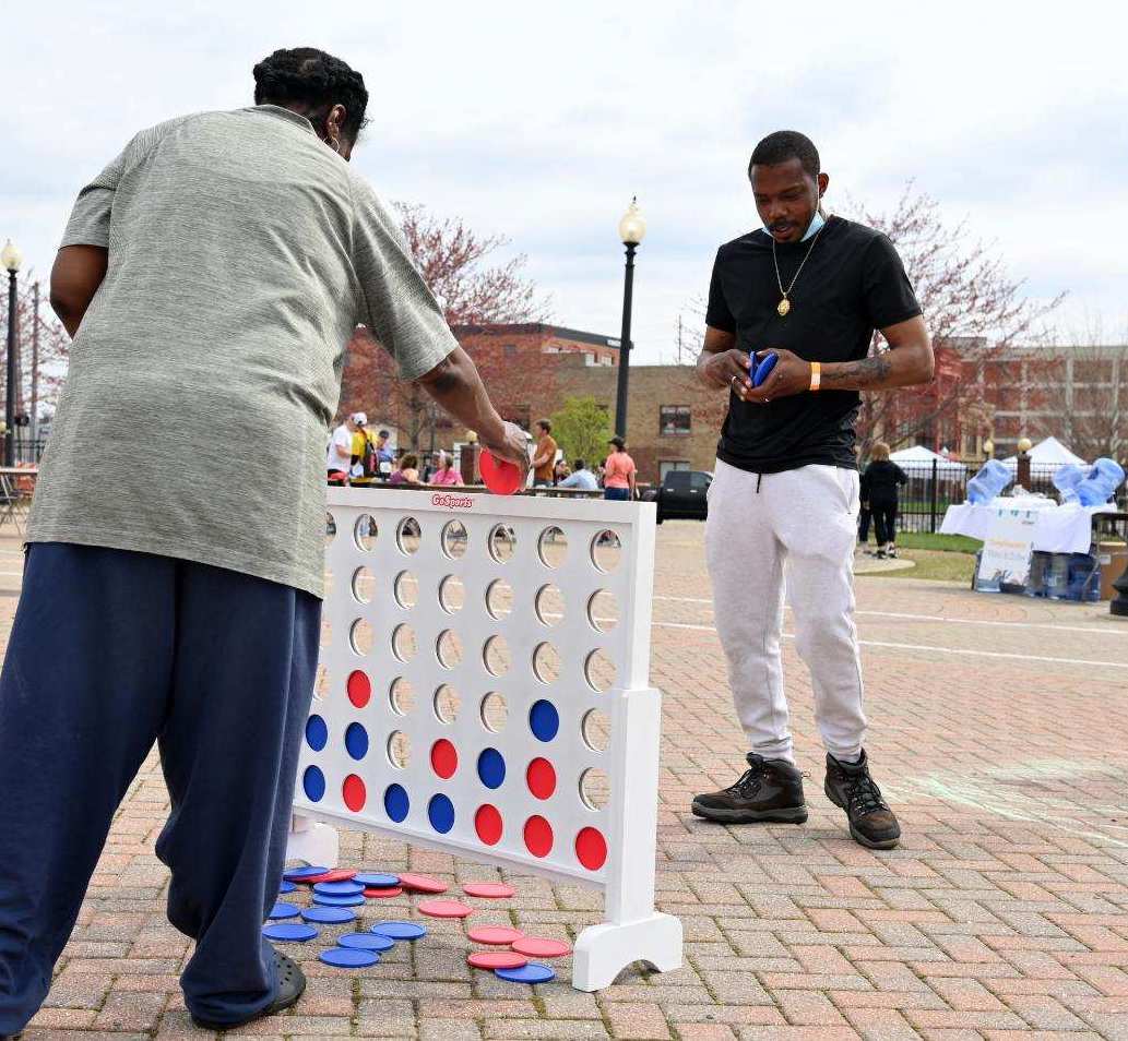 Two community members playing Connect 4 during last year’s Zeigler Kalamazoo Marathon event weekend