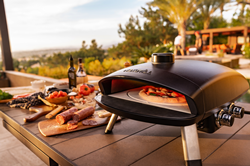 The Ora Pizza Oven is designed with a cast aluminum body and foldable legs making it both durable and portable.