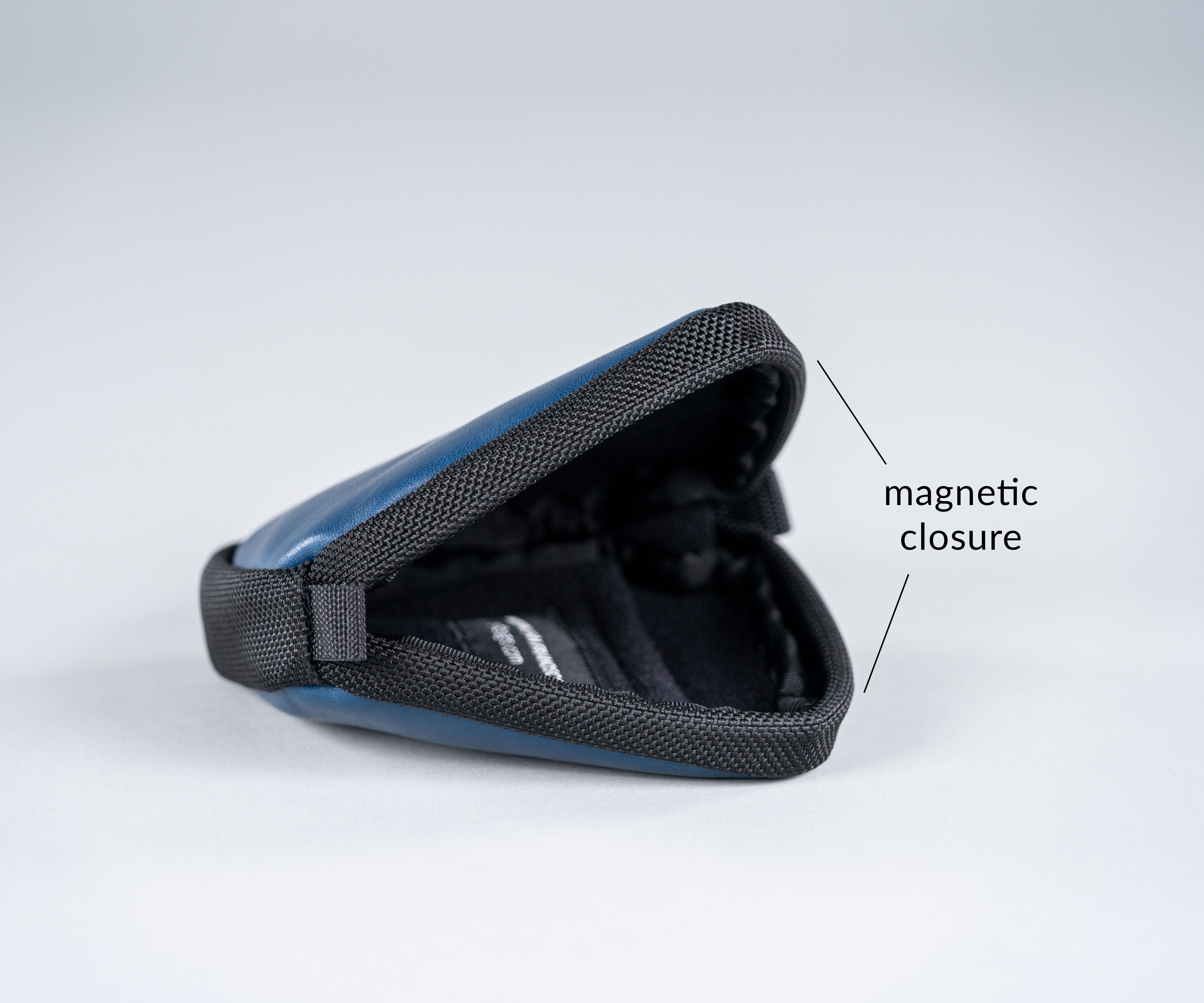 Magnetic “zipper” secures the main compartment, acts as a protective bumper, and allows in-case charging.