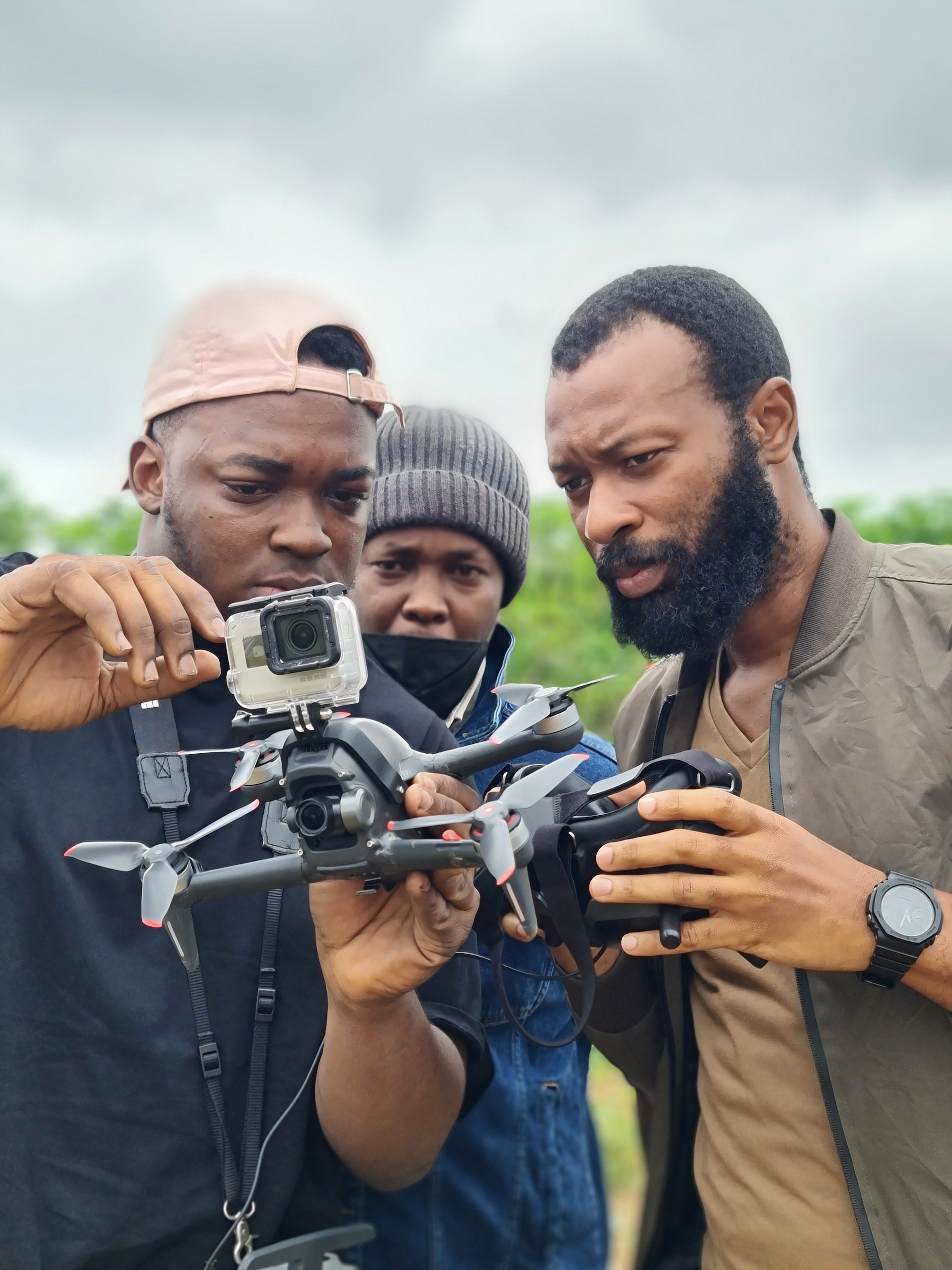 Hometeam Filmmakers Ewhubareh Eldad (left), Muchiri Njenga (center), and Muhammed Atta Ahmed (right) operate a drone in Lagos, Nigeria