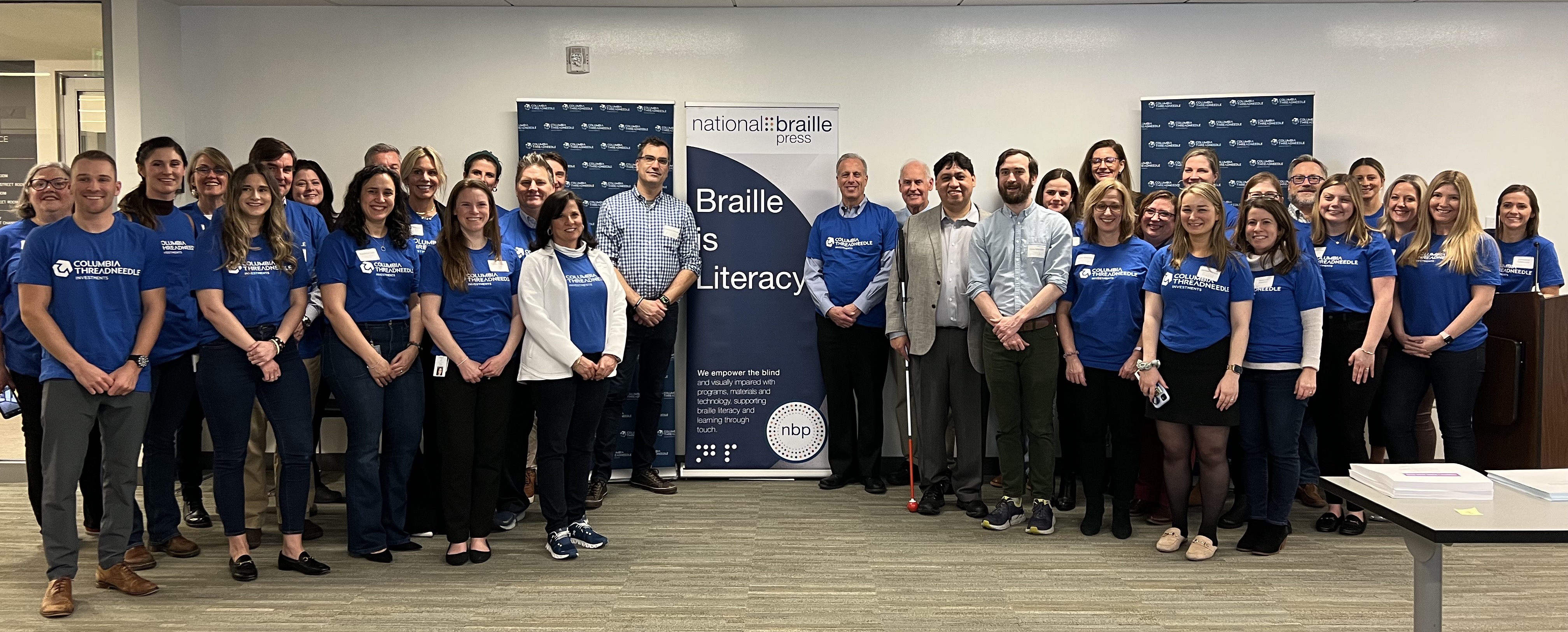 Columbia Threadneedle Investments volunteers with representatives from National Braille Press assemble the braille book Paddington