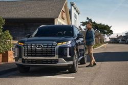 2023 Hyundai Palisade SEL parked outside a house with its owner