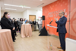 Mercy Health Services President and CEO Dr. David Maine (at right) addresses attendees for opening of the Preventive Care Center in downtown Baltimore, MD.