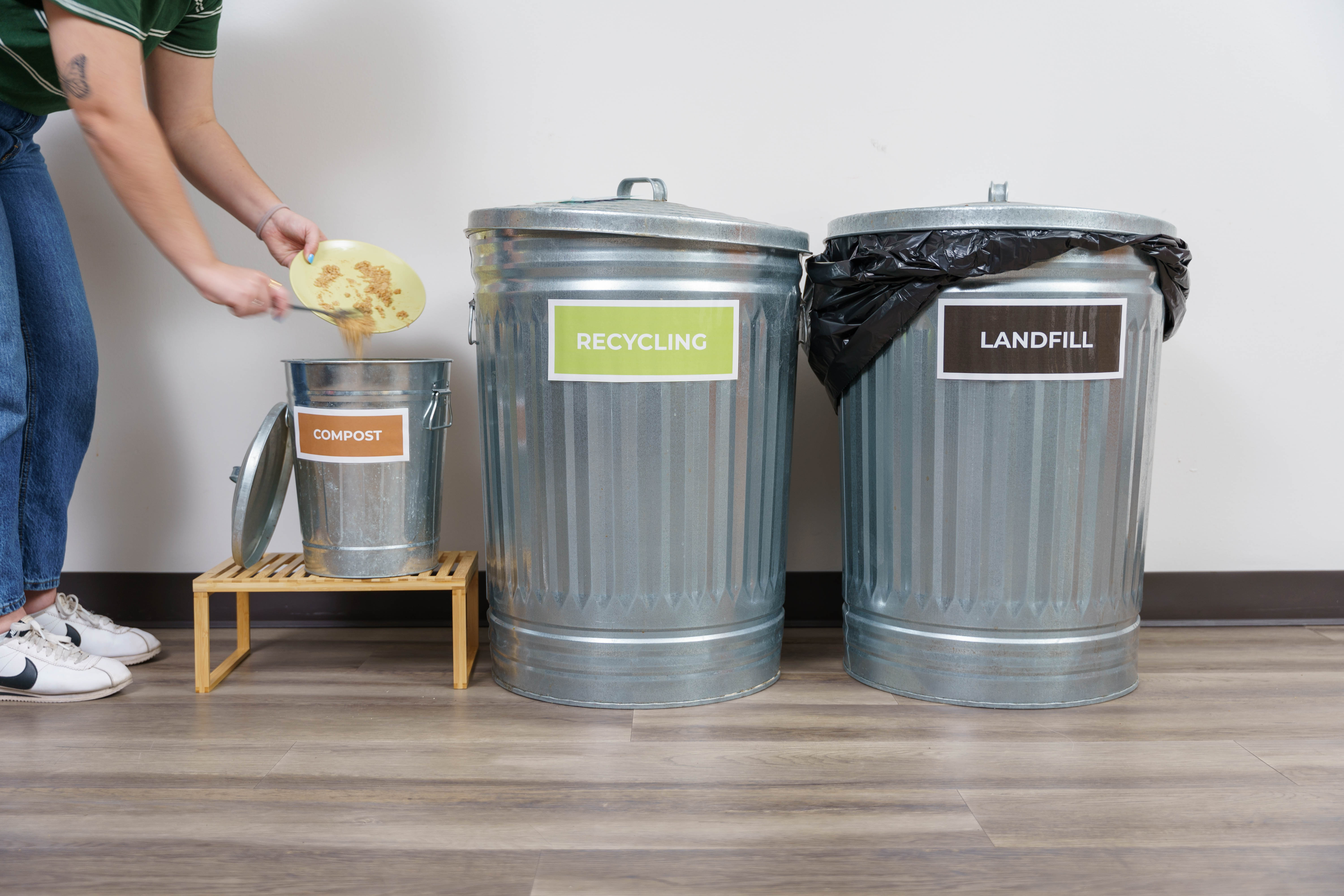 A Wondercide teammate in the Austin, TX company kitchen helps sort waste to support local recycling efforts.