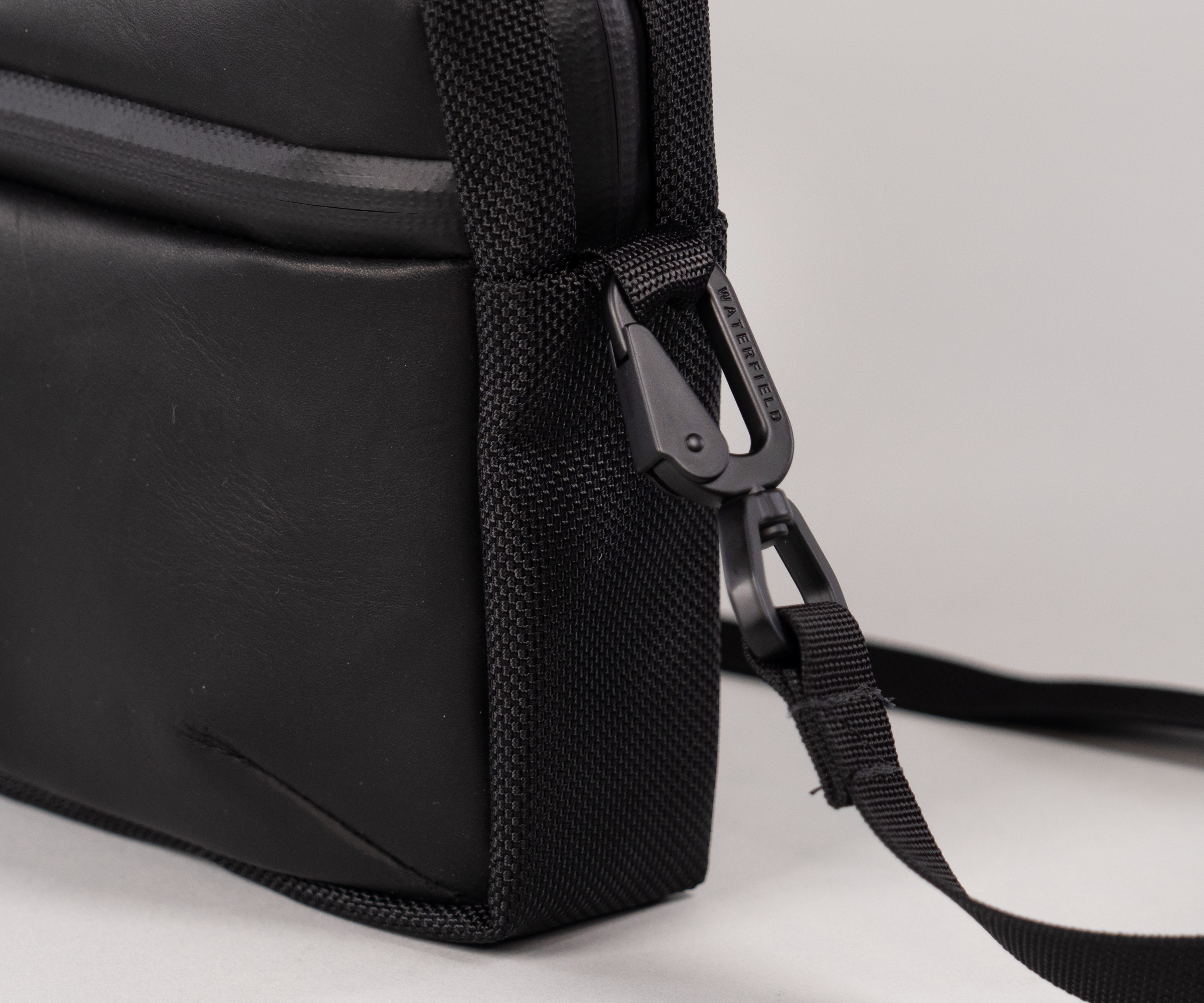 Removable strap attaches with custom metal hardware