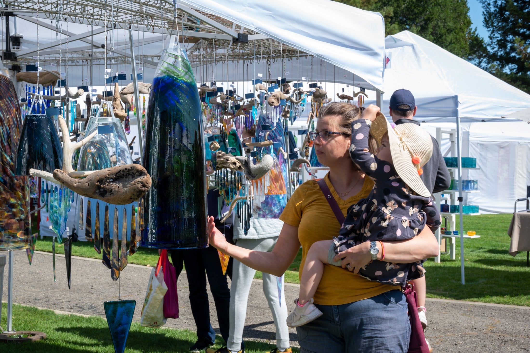 A shopper browses unique art at the Rotary of Saratoga's Fine Arts Show