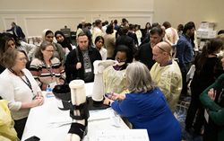 Meeting attendees viewing a wound care demonstration