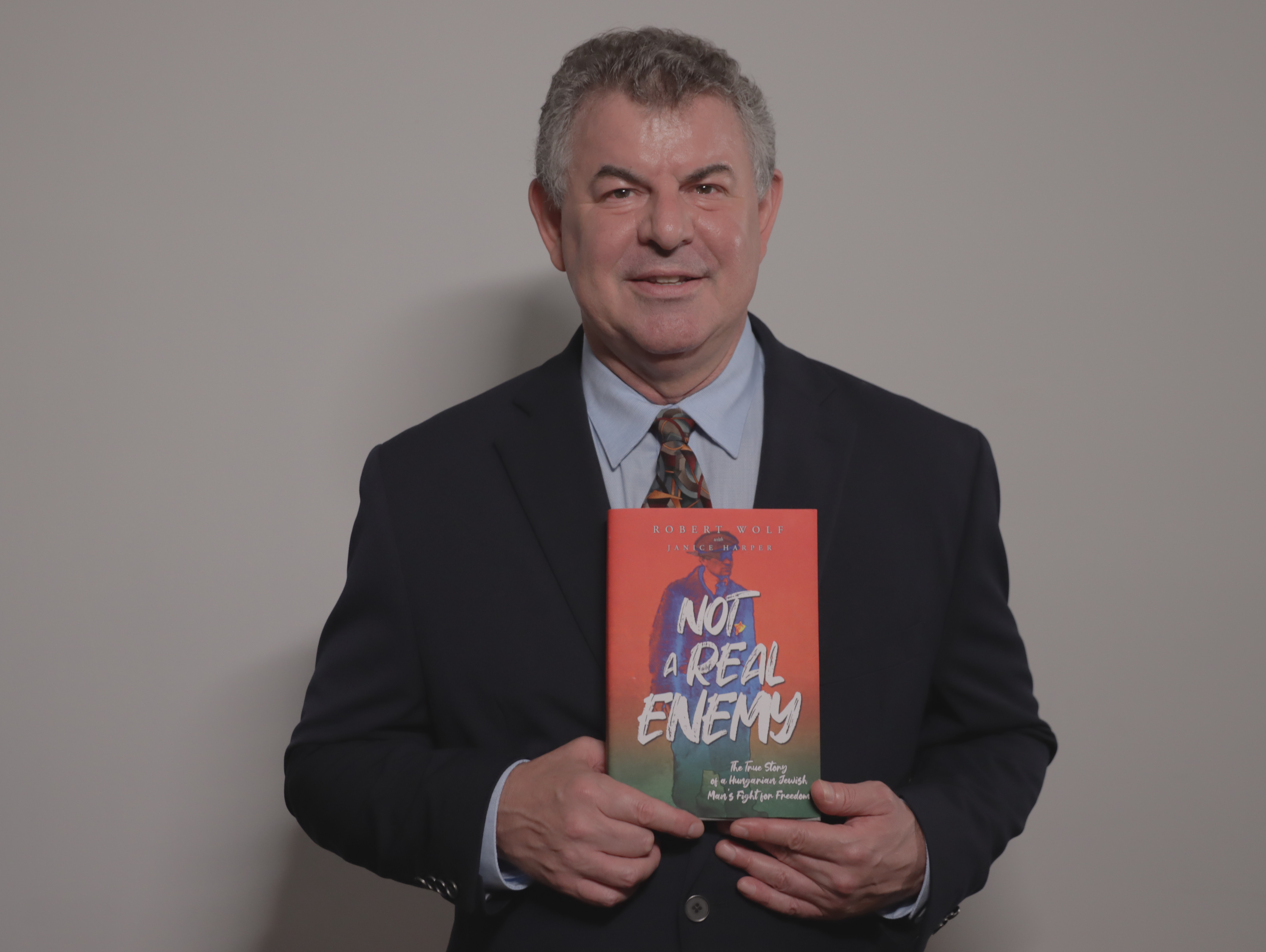 Author Robert Wolf with Not a Real Enemy book