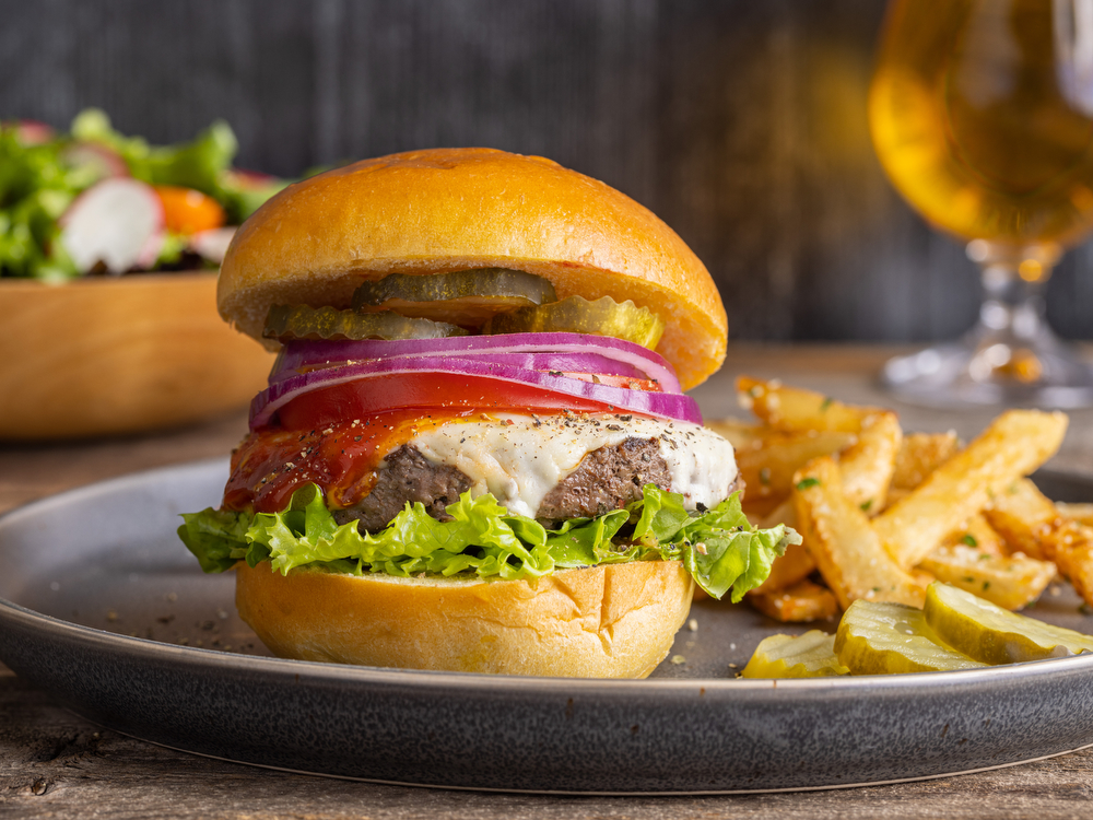 Morgan Brook Farm Wagyu burger on a bun with fries and a beer.