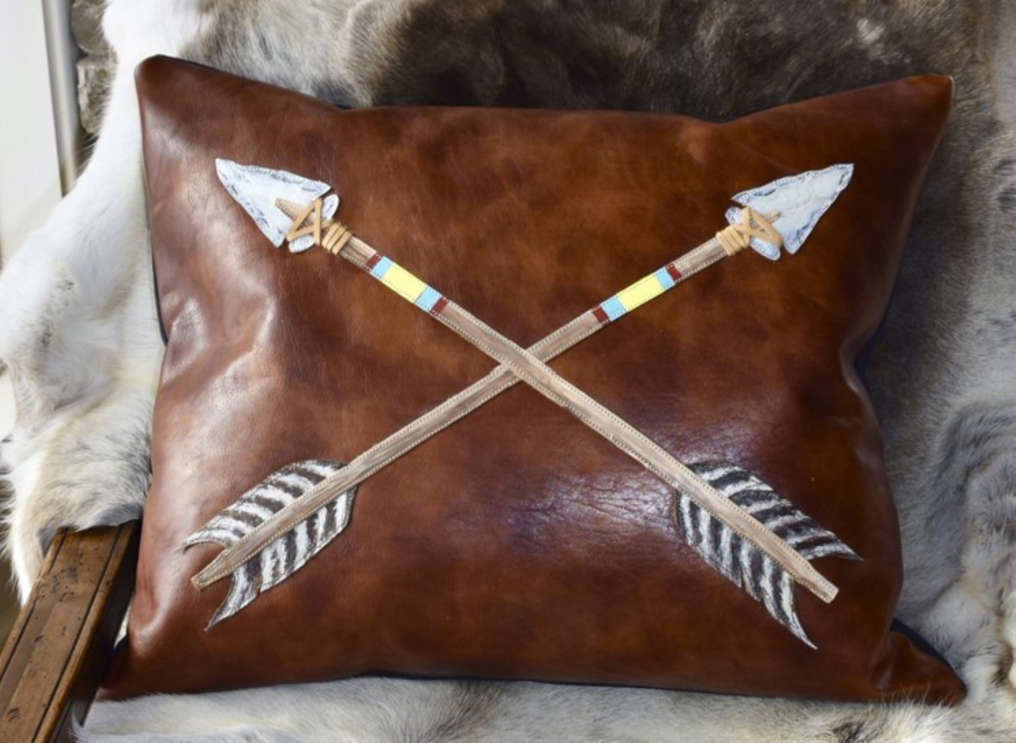 This leather pillow hand-appliquéd by BRIDGERHome artist Jenny Keller is an example of the handcrafted functional art available to purchase at the Western Design Conference Exhibit + Sale.